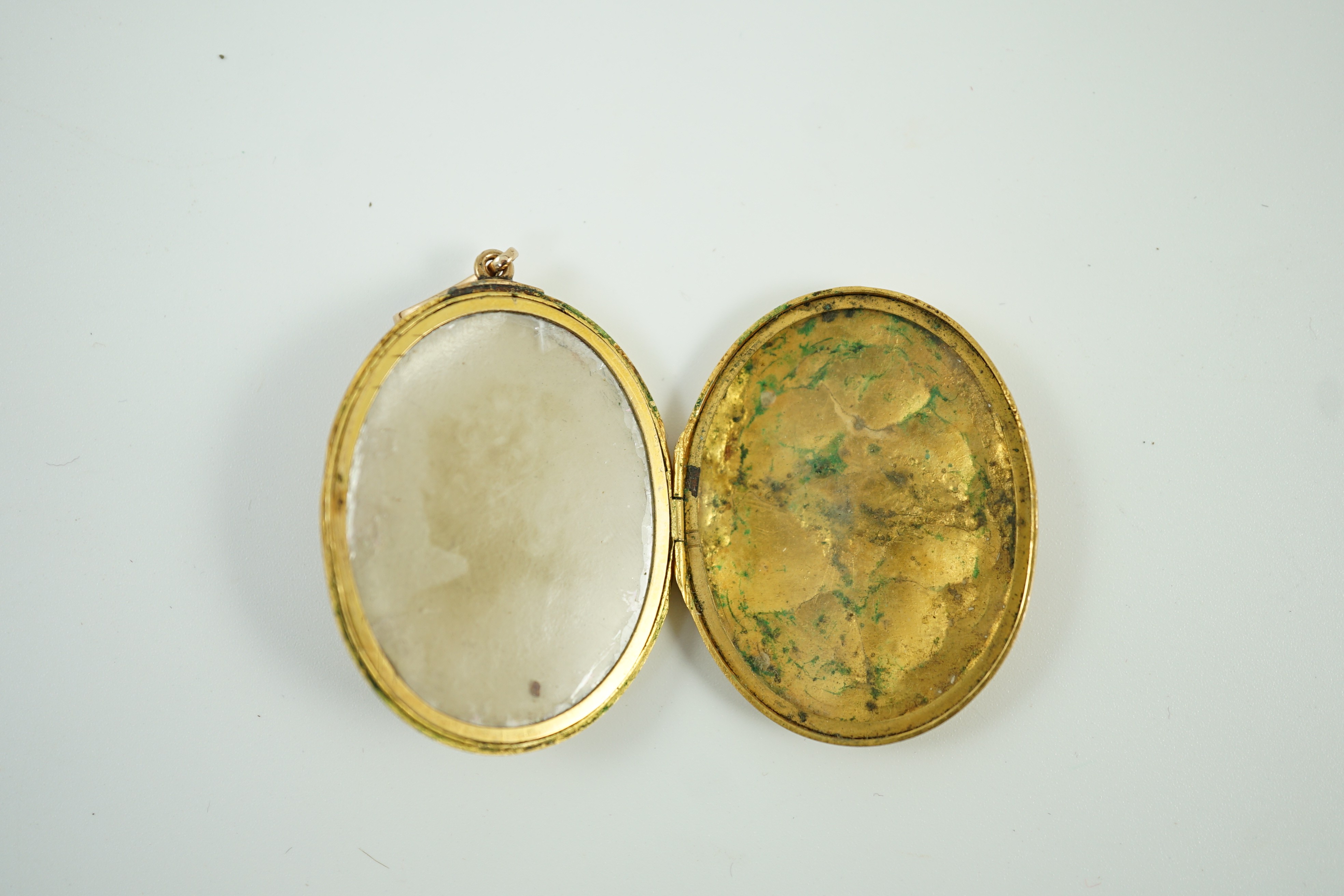 A Victorian yellow metal, blue enamel and seed pearl set oval locket, 40mm, gross weight 13.8 grams.